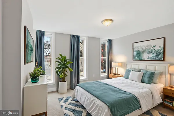 a bedroom with a bed and a potted plant