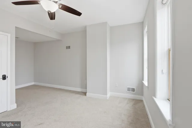 a bathroom with a toilet a sink a mirror and a faucet