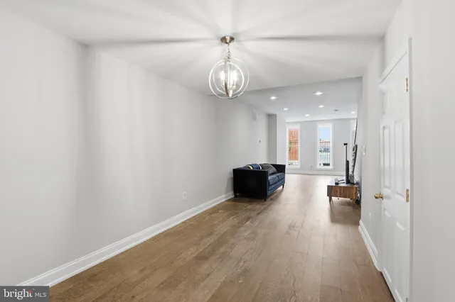 a big room with wooden floor a chandelier