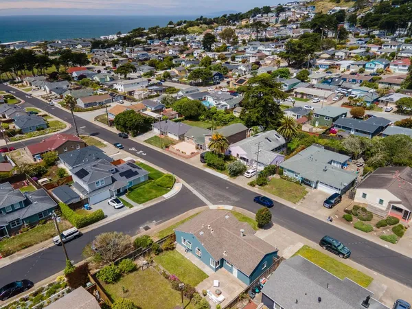 an aerial view of residential houses with outdoor space