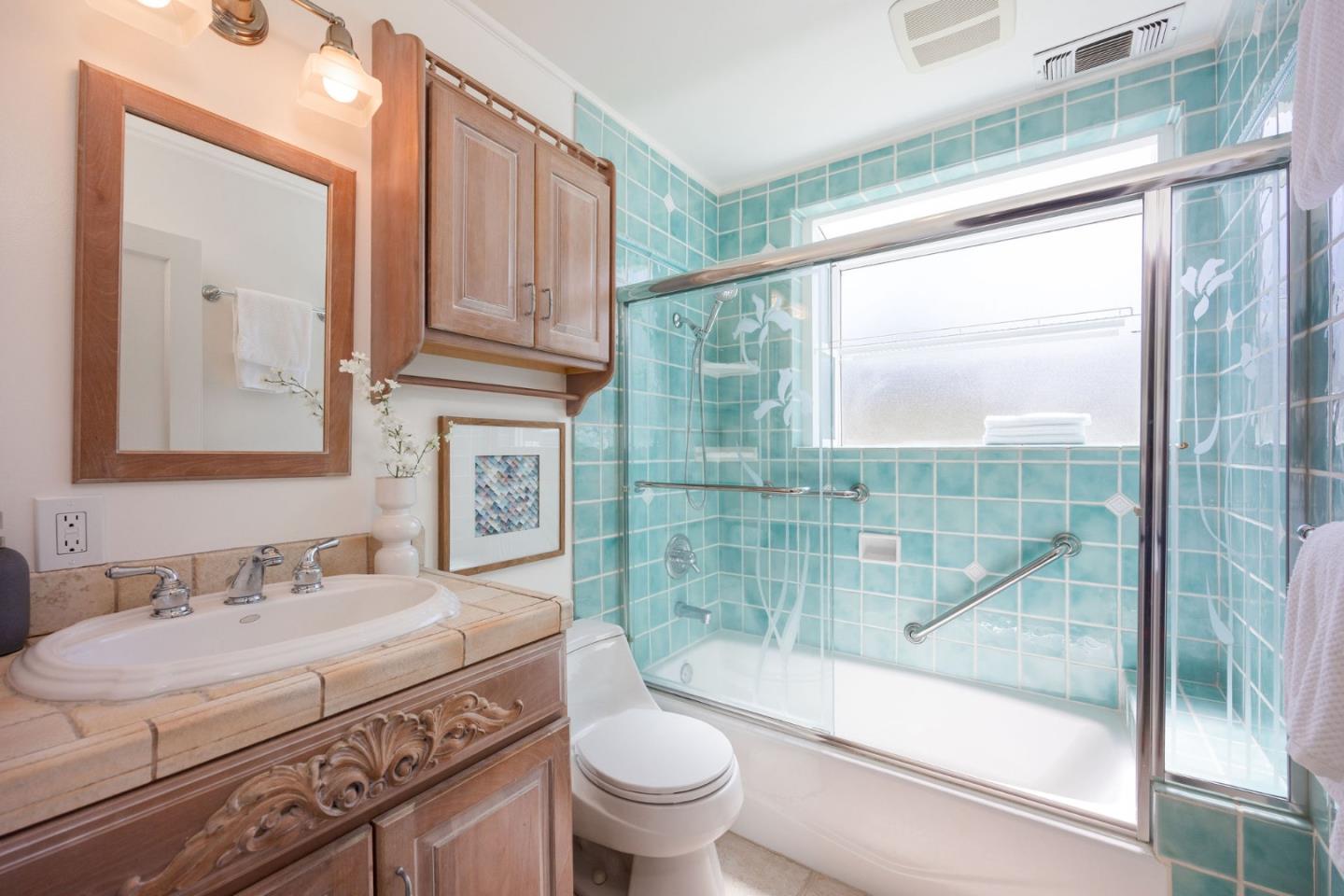 304 Nelson Avenue Pacifica, CA 94044 - Photo 29 of 39 a bathroom with a granite countertop sink a toilet a mirror and shower
