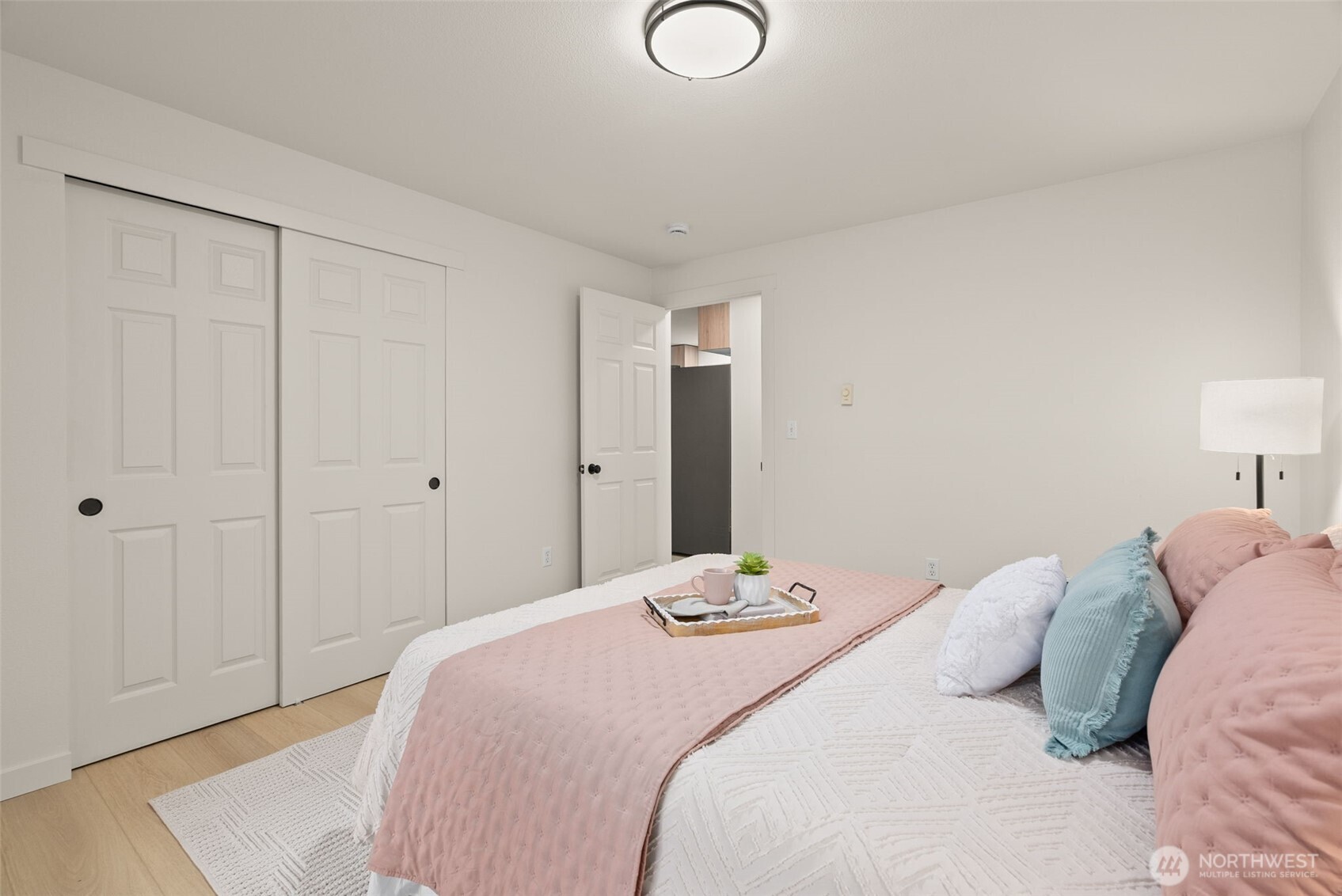7605 Northeast Hidden Cove Road Bainbridge Island, WA 98110 - Photo 11 of 39 a bedroom with a bed and pillows