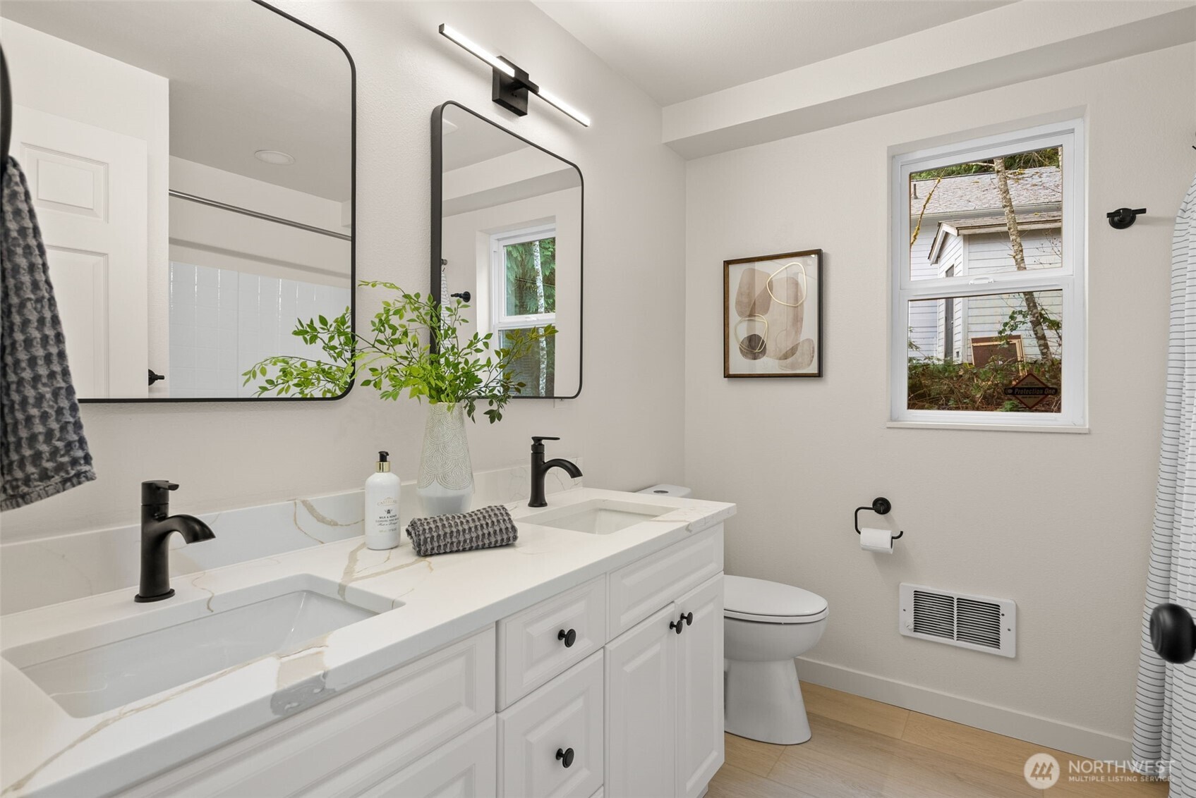 7605 Northeast Hidden Cove Road Bainbridge Island, WA 98110 - Photo 12 of 39 a bathroom with a toilet sink and mirror