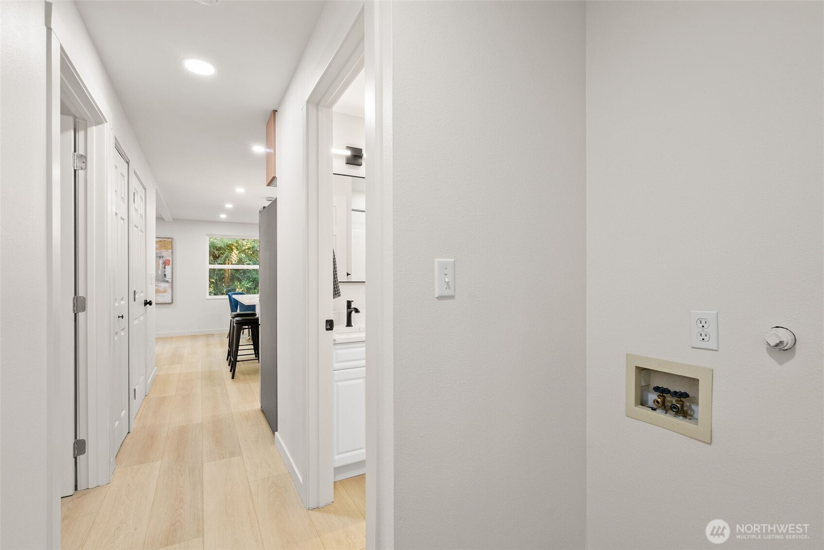7605 Northeast Hidden Cove Road Bainbridge Island, WA 98110 - Photo 13 of 39 a view of a hallway with wooden shelves