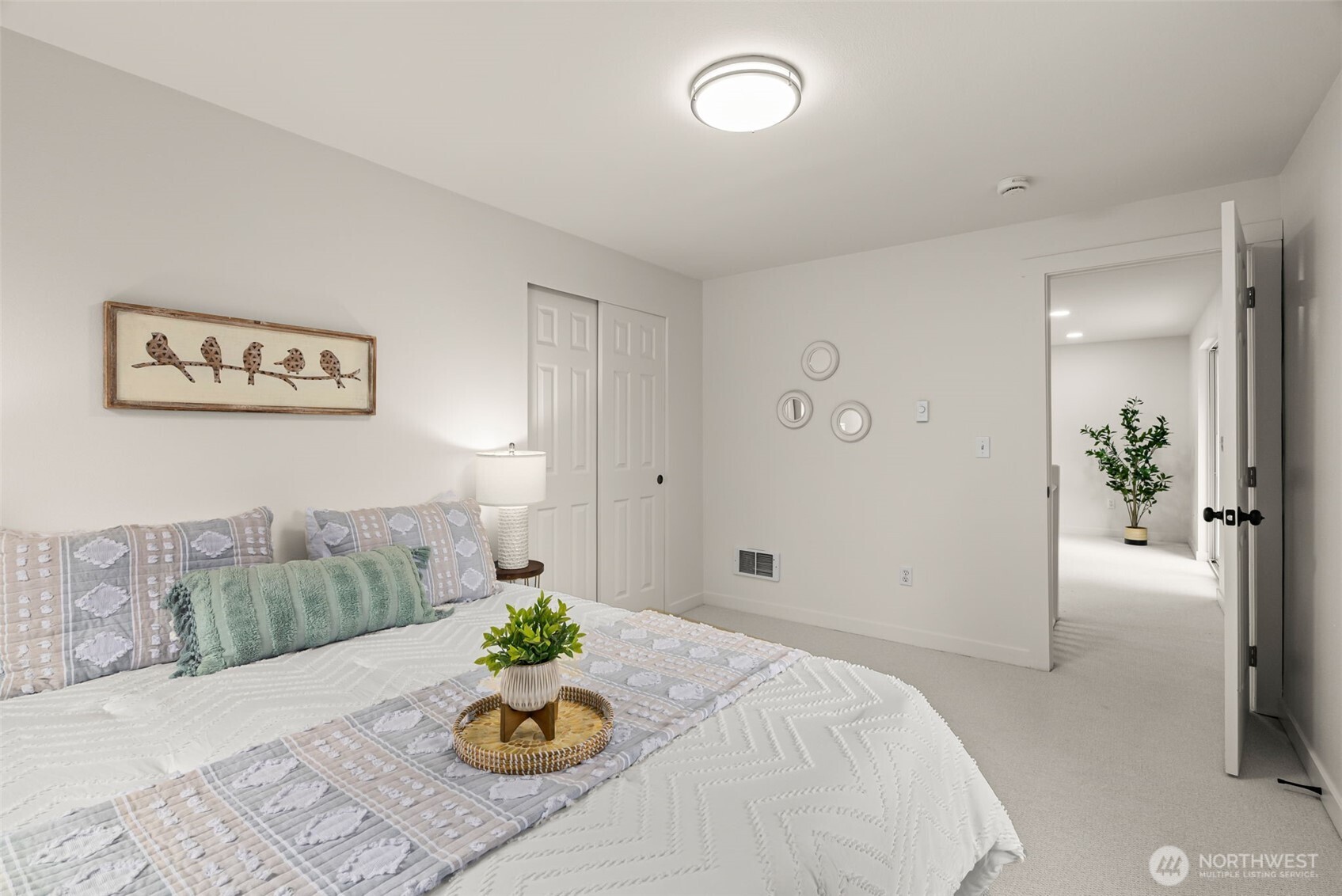 7605 Northeast Hidden Cove Road Bainbridge Island, WA 98110 - Photo 21 of 39 a bed room with a bed and a couch