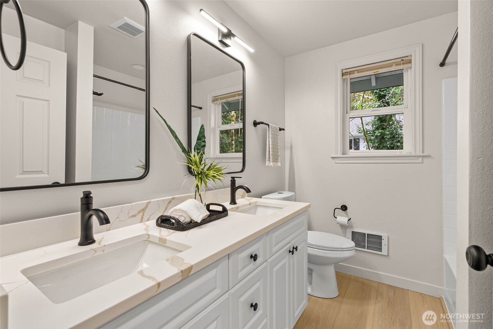 7605 Northeast Hidden Cove Road Bainbridge Island, WA 98110 - Photo 23 of 39 a bathroom with a granite countertop sink a toilet and a mirror