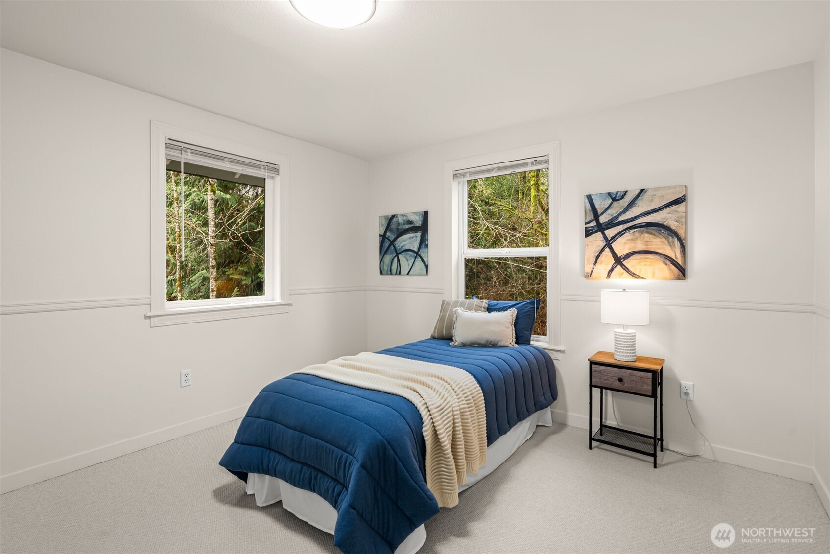 7605 Northeast Hidden Cove Road Bainbridge Island, WA 98110 - Photo 24 of 39 a bedroom with a bed and a window