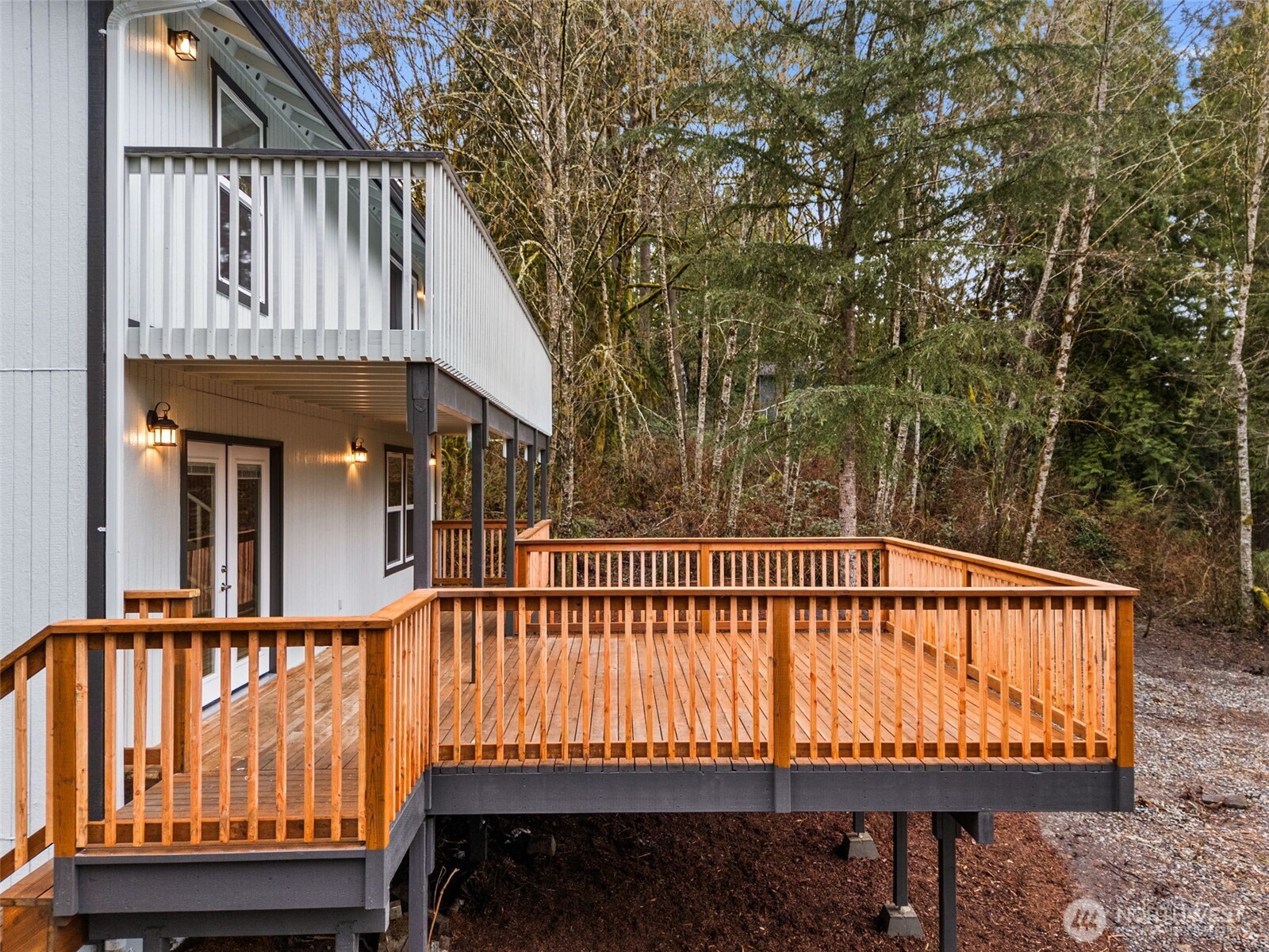 7605 Northeast Hidden Cove Road Bainbridge Island, WA 98110 - Photo 26 of 39 a view of a house with a wooden deck
