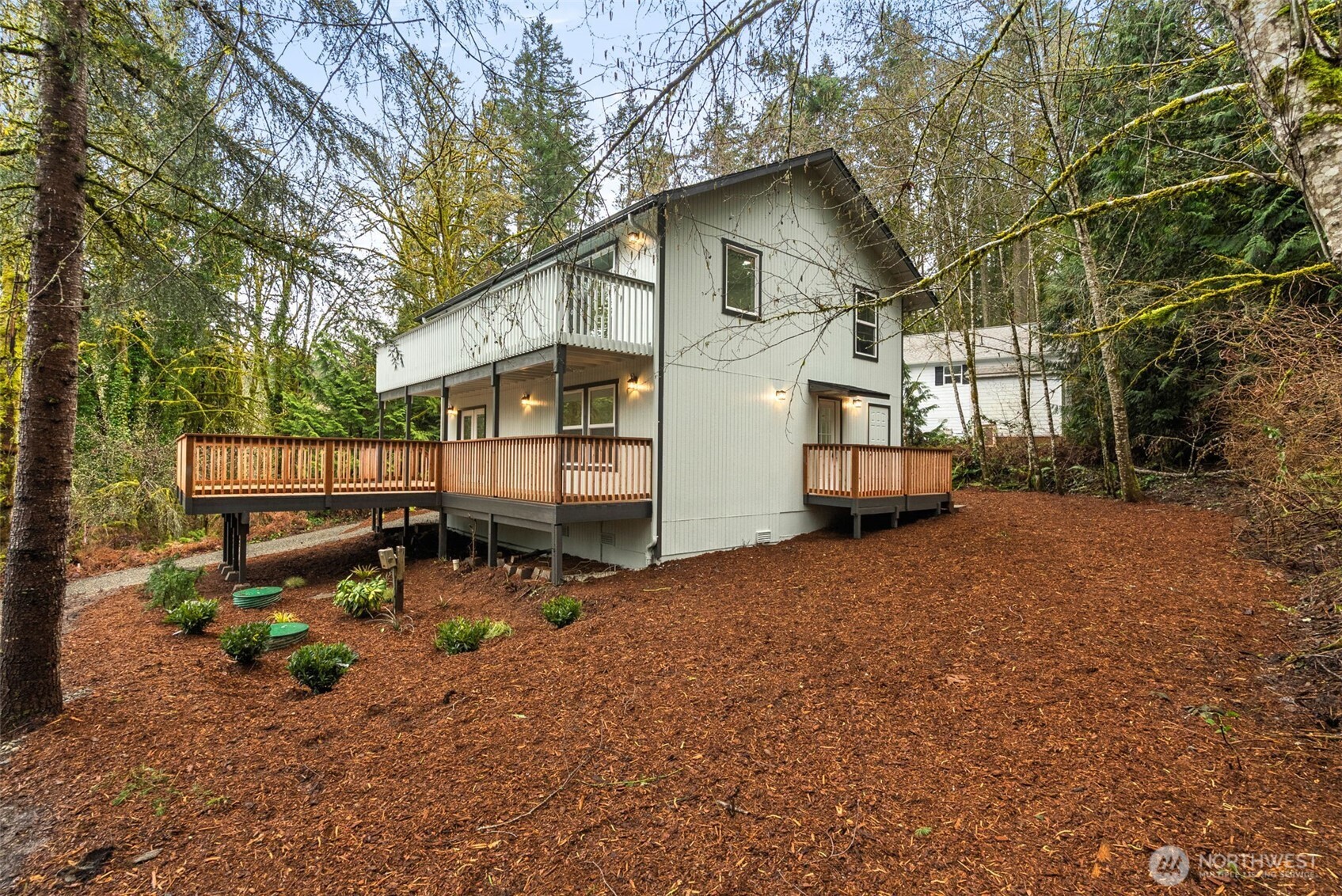 7605 Northeast Hidden Cove Road Bainbridge Island, WA 98110 - Photo 28 of 39 a backyard of a house with fire pit and outdoor seating