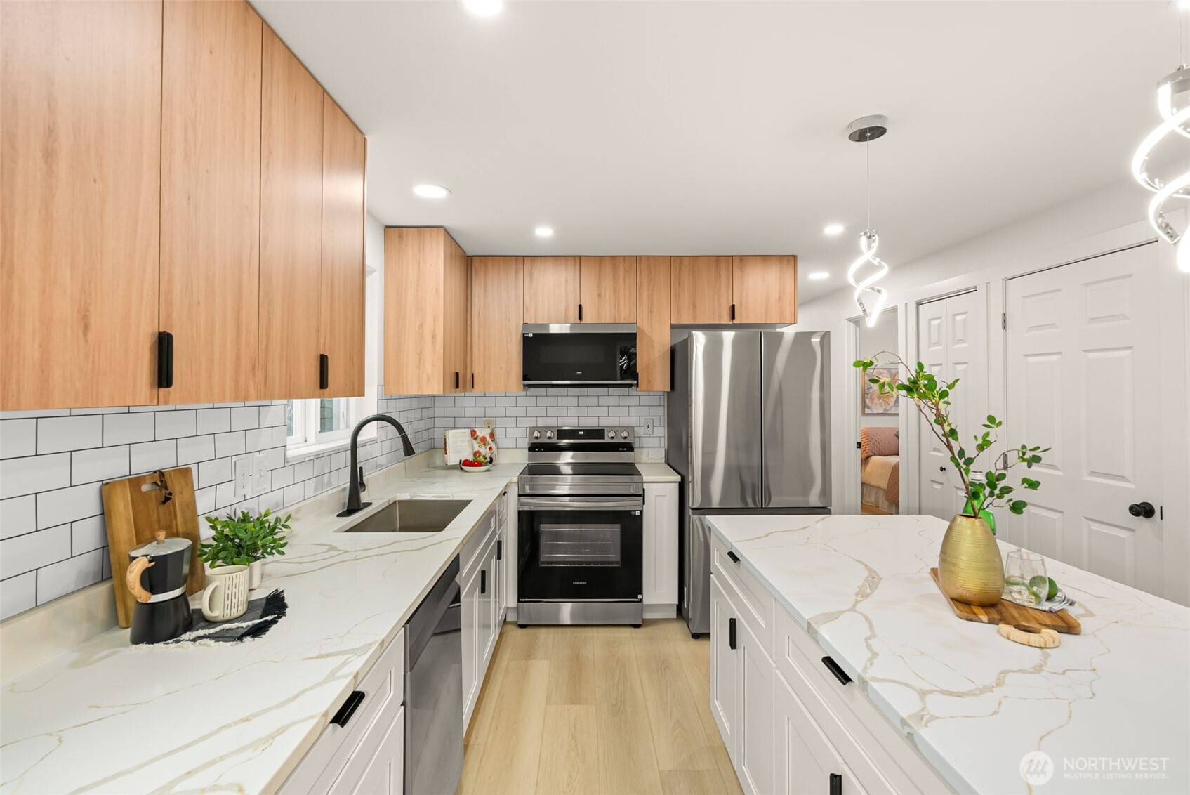 7605 Northeast Hidden Cove Road Bainbridge Island, WA 98110 - Photo 3 of 39 a kitchen with refrigerator a sink and microwave