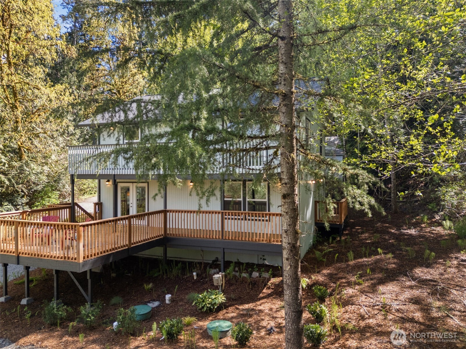 7605 Northeast Hidden Cove Road Bainbridge Island, WA 98110 - Photo 38 of 39 a view of a house with a small yard and wooden fence