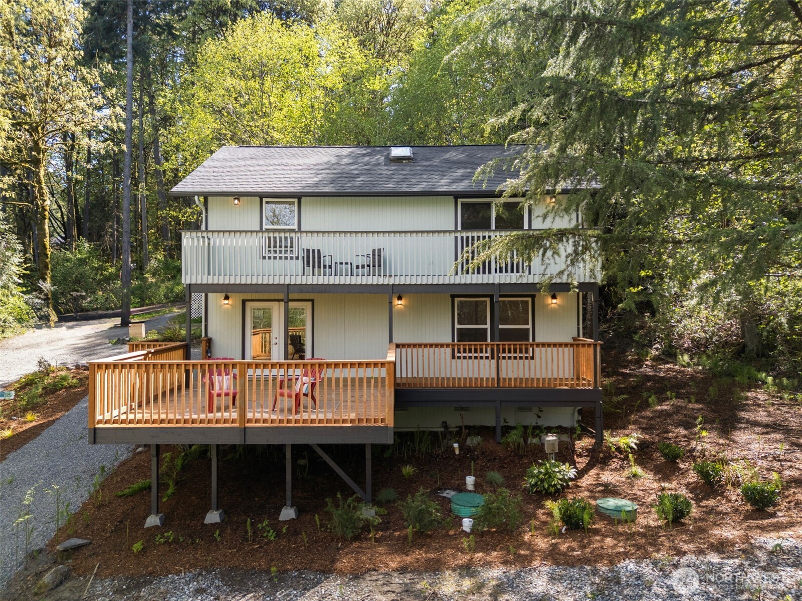 7605 Northeast Hidden Cove Road Bainbridge Island, WA 98110 - Photo 39 of 39 an aerial view of a house with deck yard and outdoor seating