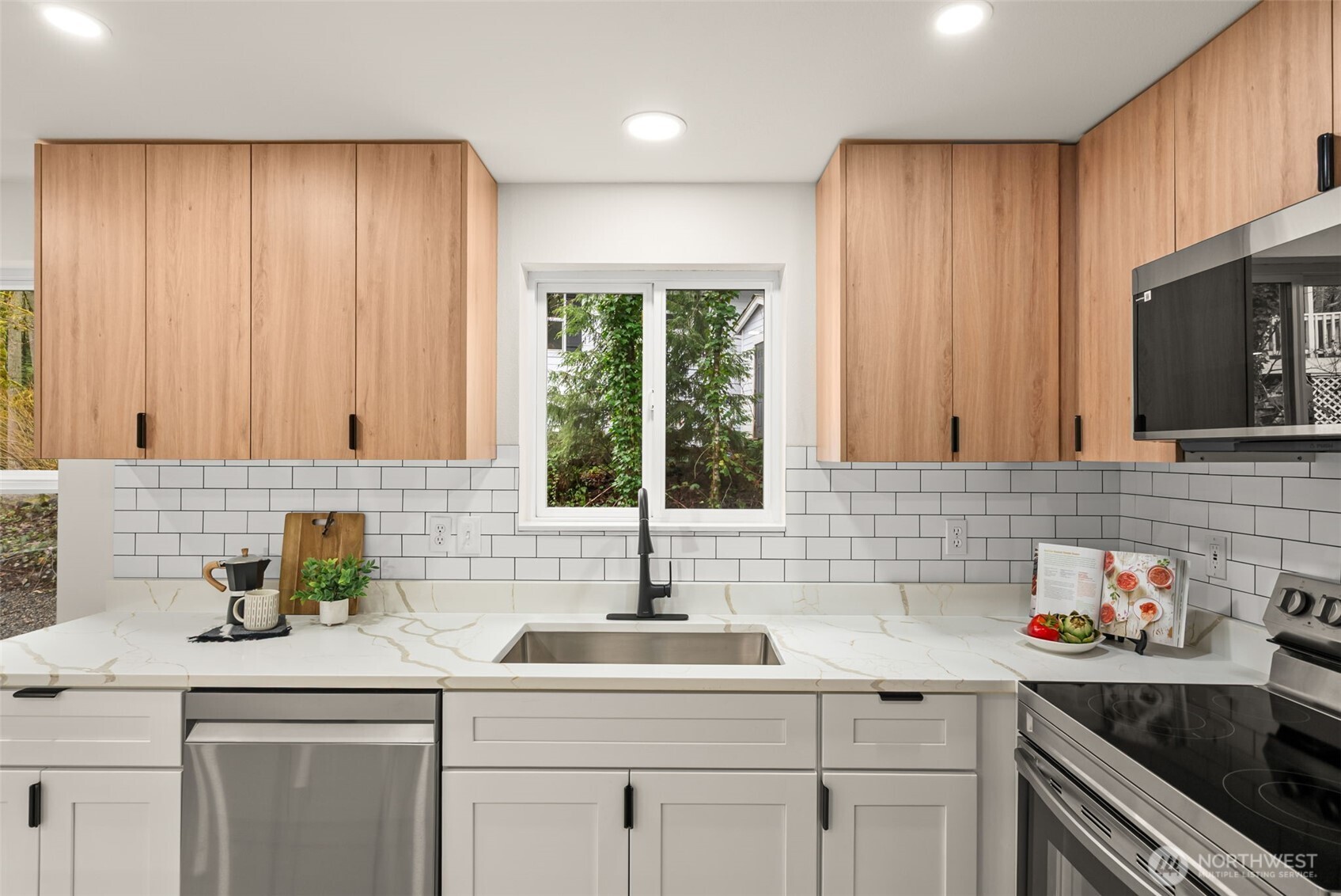 7605 Northeast Hidden Cove Road Bainbridge Island, WA 98110 - Photo 8 of 39 a kitchen with a sink cabinets and a window