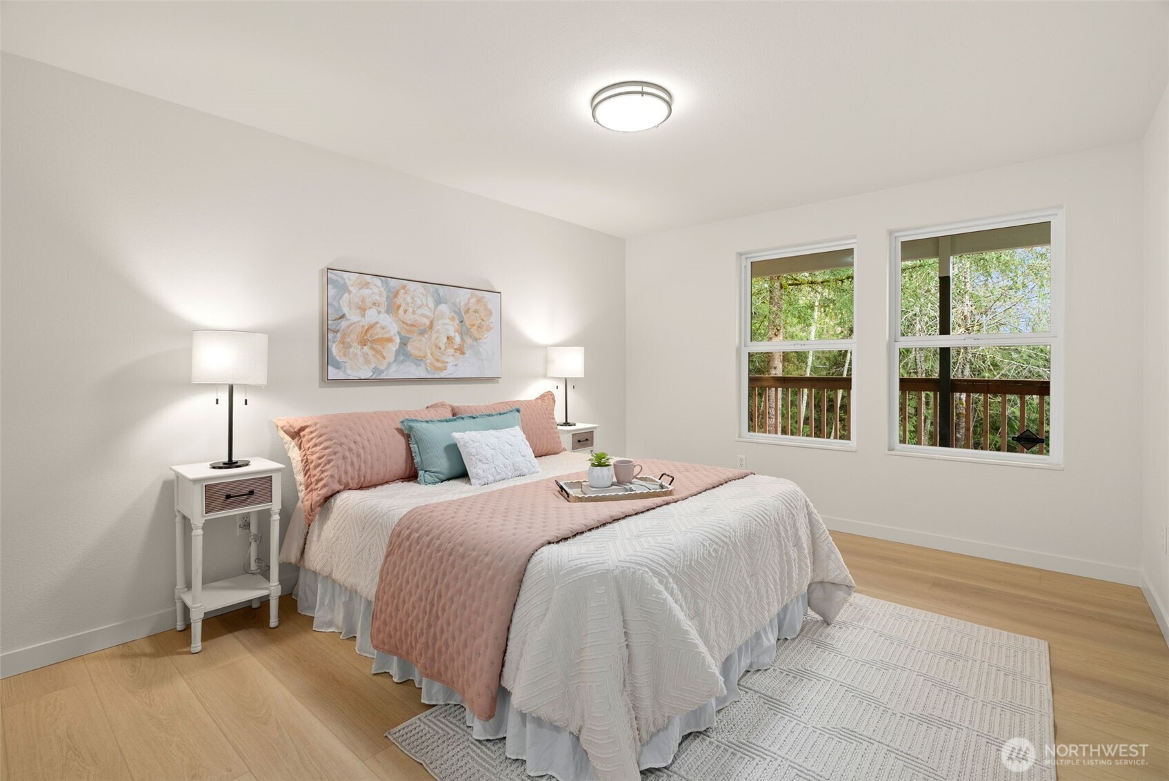 7605 Northeast Hidden Cove Road Bainbridge Island, WA 98110 - Photo 10 of 39 a bedroom with a bed and a night stand