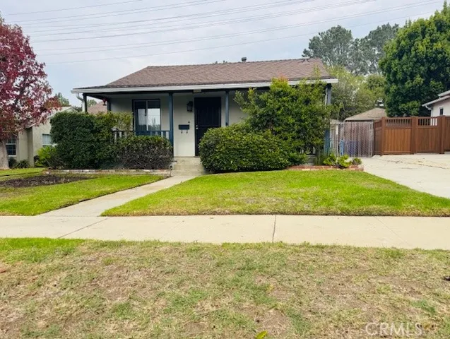 a view of a house with a yard and plants