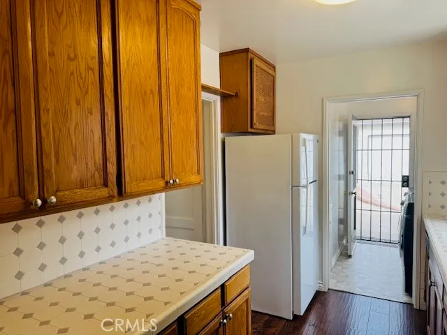 an entryway with wooden floor and cabinet