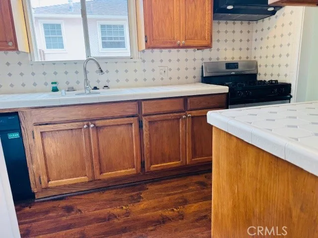an empty room with wooden floor and a window