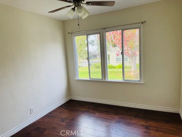 an empty room with wooden floor and closet area