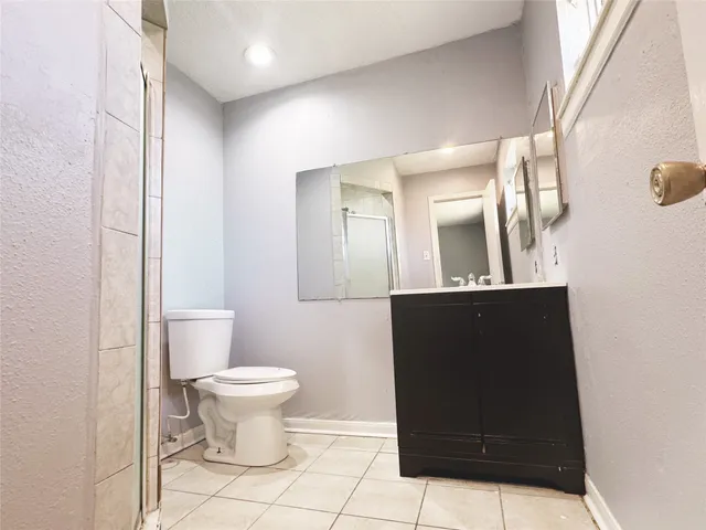 a bathroom with a glass shower door