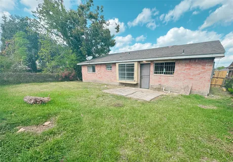 a front view of house with yard and trees