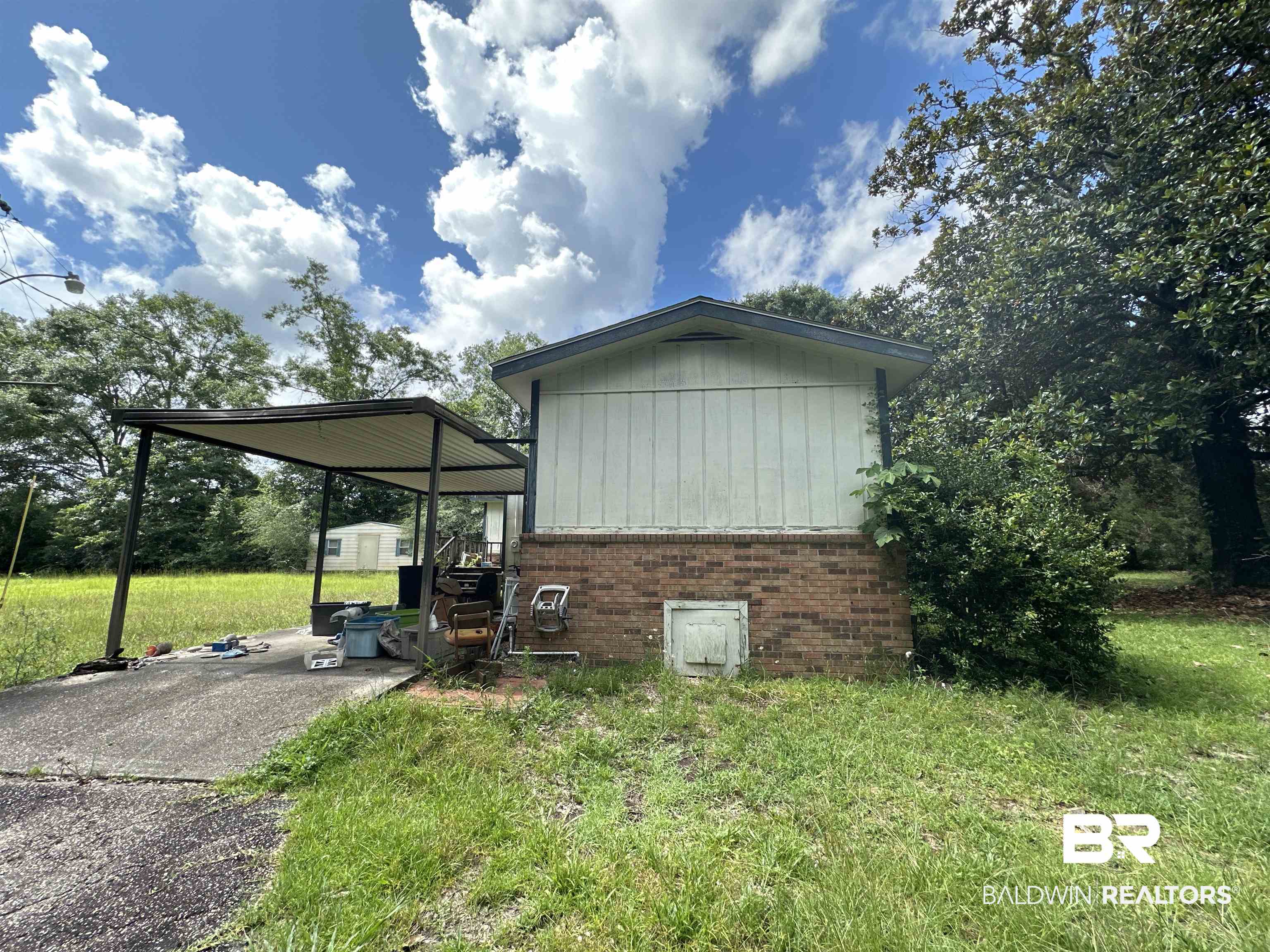 1850 Repoll Drive Mobile, AL 36695 - Photo 19 of 26 View of home's exterior featuring a lawn