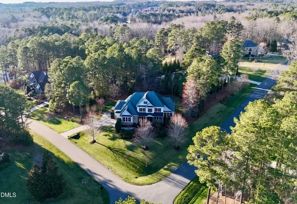 an aerial view of a house with garden space ocean view