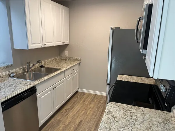 a kitchen with a sink and a refrigerator