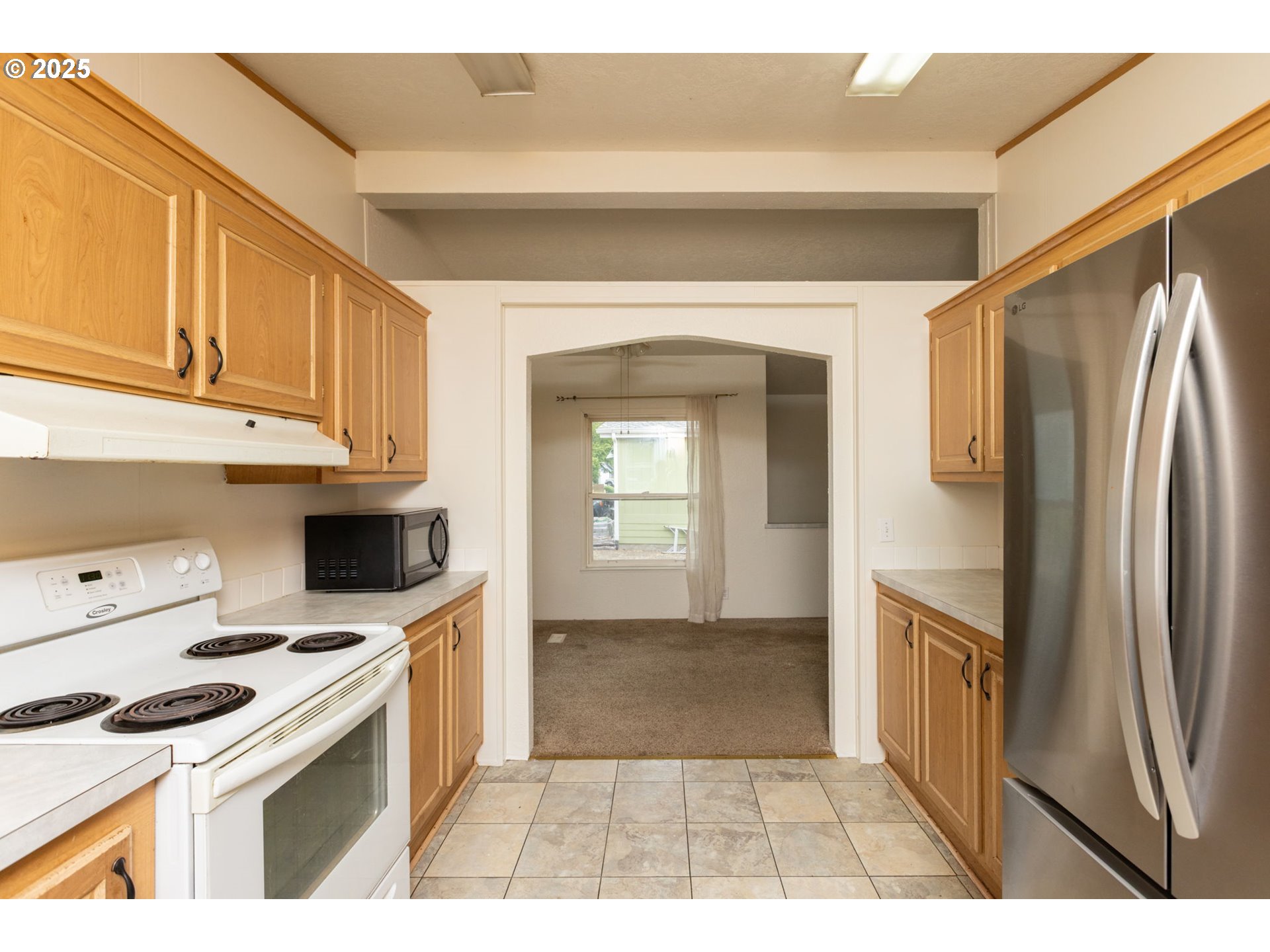 1655 South Elm Street Canby, OR 97013 - Photo 11 of 32 a kitchen with stainless steel appliances a refrigerator a stove a sink and cabinets
