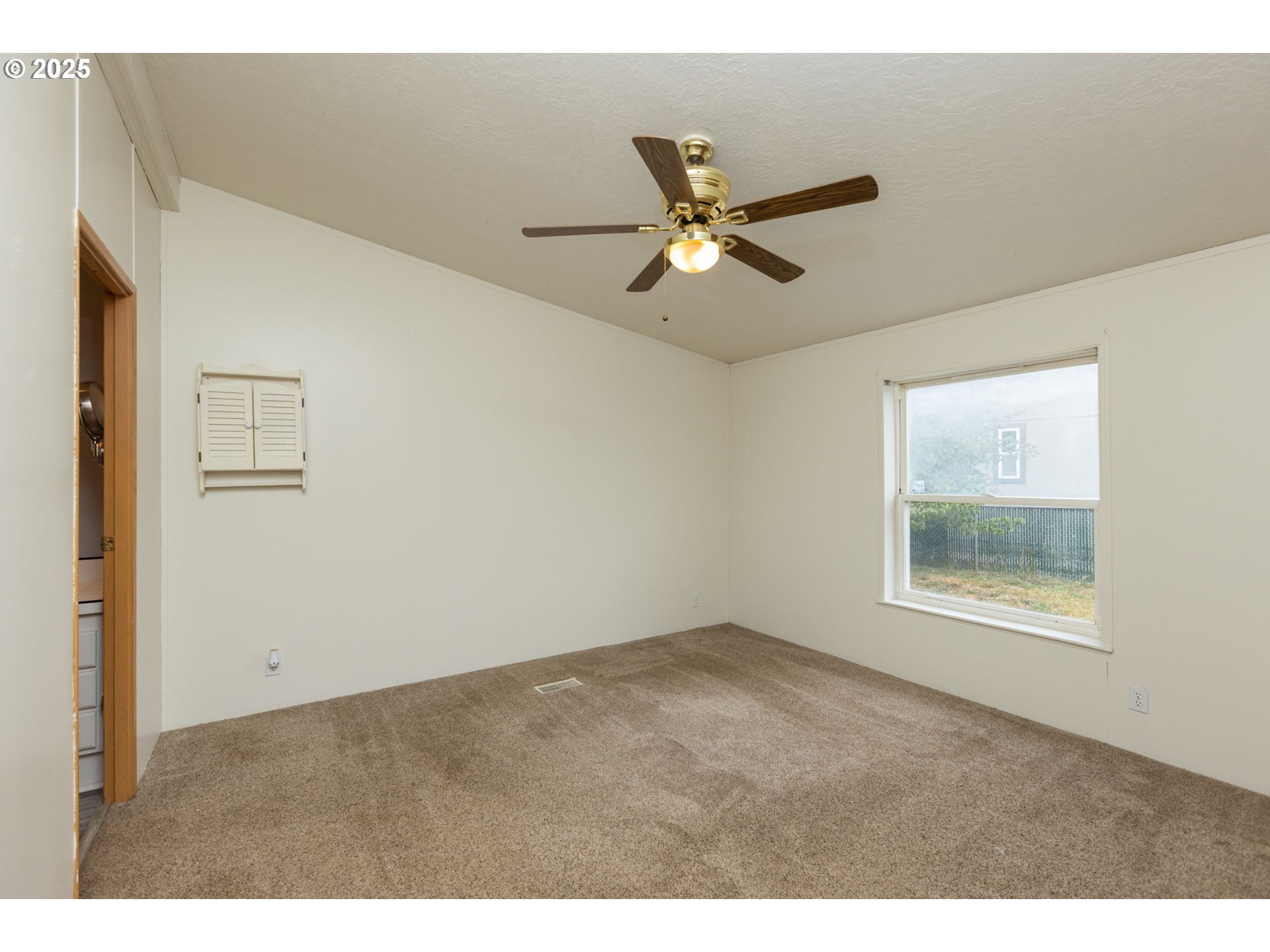 1655 South Elm Street Canby, OR 97013 - Photo 13 of 32 a view of an empty room with a window