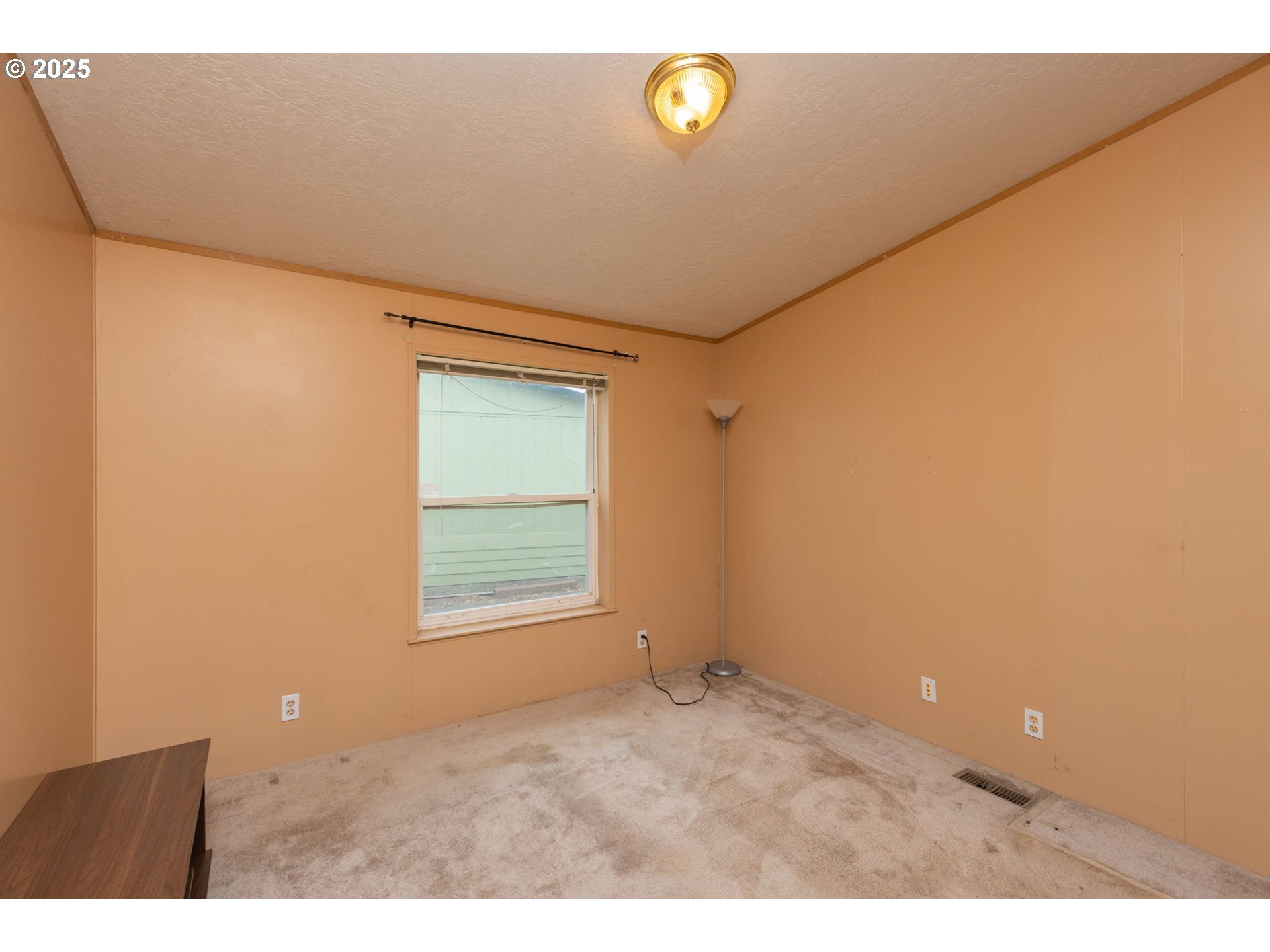 1655 South Elm Street Canby, OR 97013 - Photo 21 of 32 a view of an empty room with a window