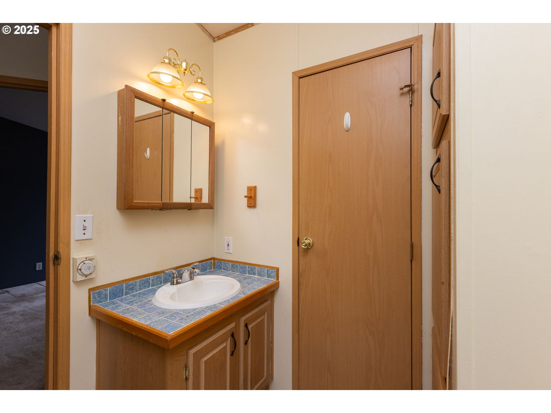 1655 South Elm Street Canby, OR 97013 - Photo 24 of 32 a bathroom with a sink a mirror and a shower