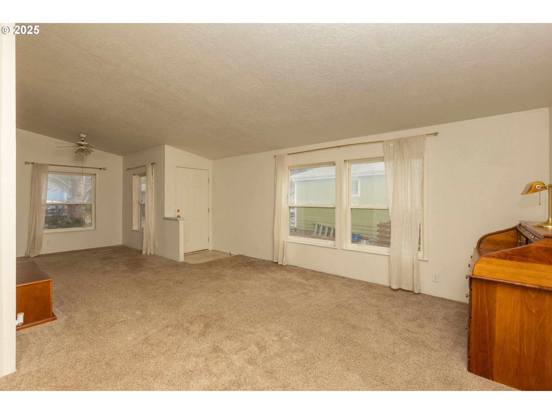 1655 South Elm Street Canby, OR 97013 - Photo 4 of 32 a view of an empty room with a window