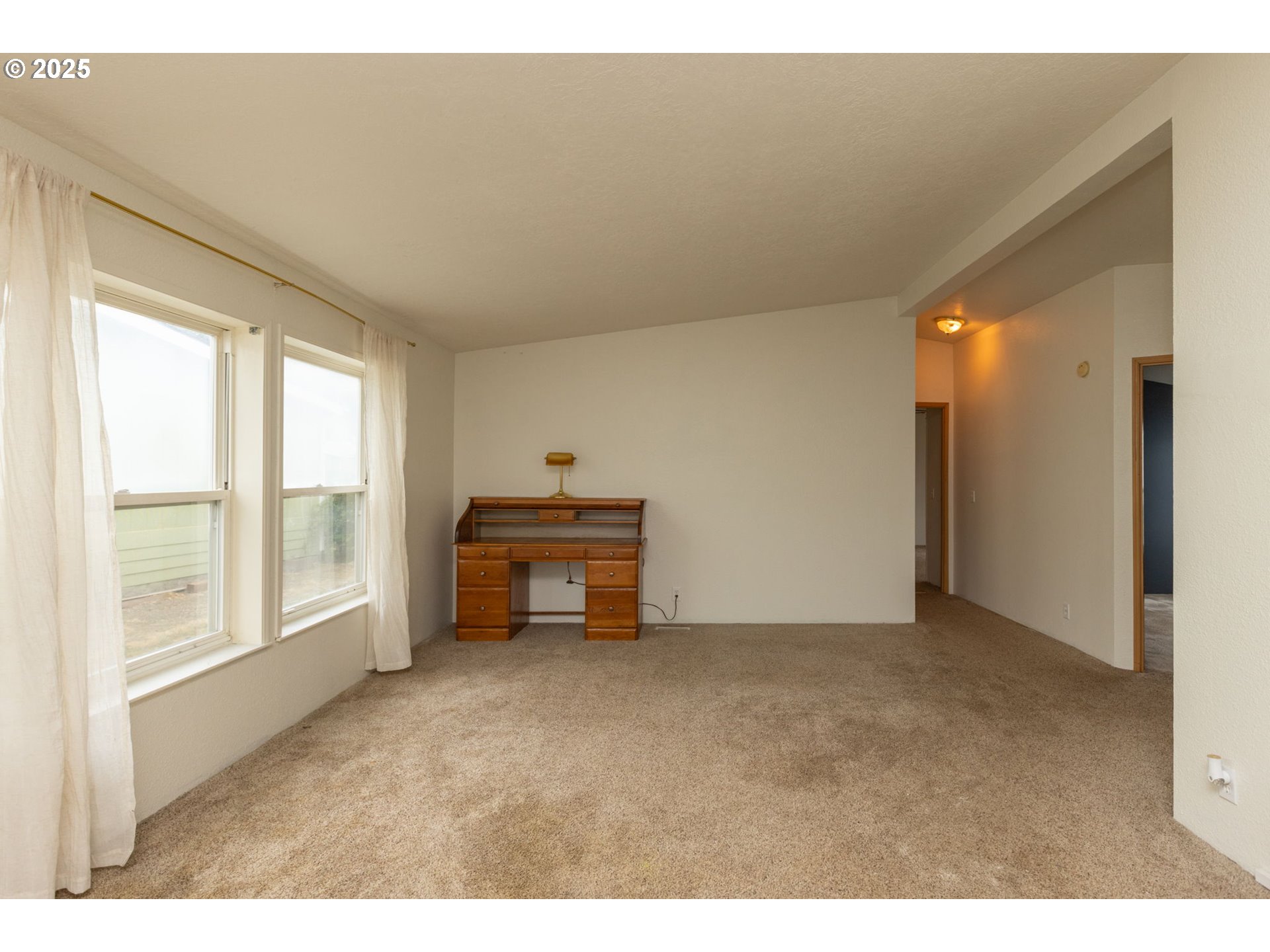 1655 South Elm Street Canby, OR 97013 - Photo 5 of 32 a view of an empty room with a window