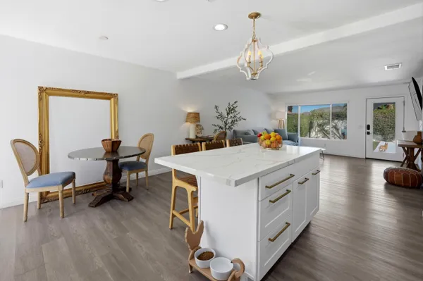 a view of kitchen with dining table and chairs