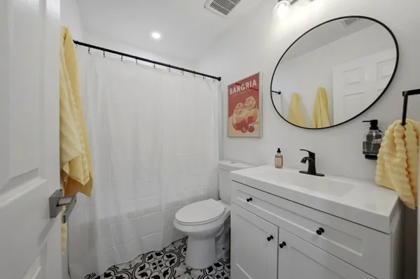 a bathroom with a sink mirror and toilet