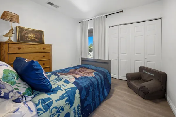 a bedroom with a bed couch and a window