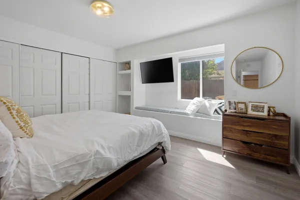 a bedroom with a bed and a large window