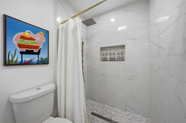 a bathroom with a toilet a sink and a shower