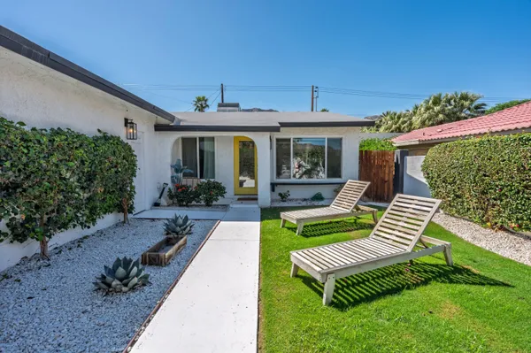 a view of a patio with couches chairs and a potted plant