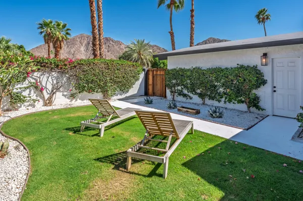 a view of a chair and table in the garden