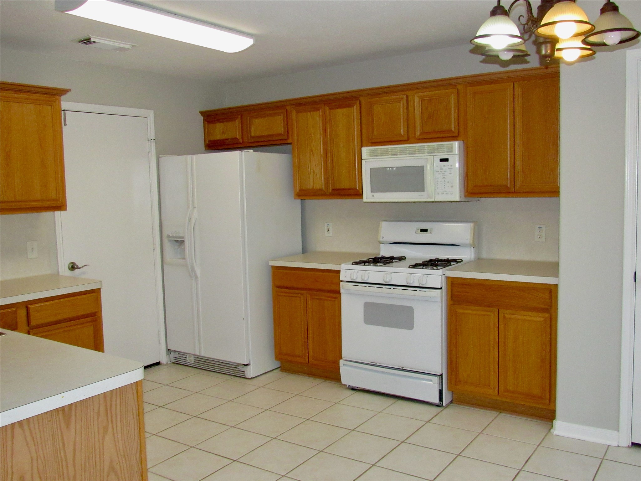 3231 Stoneydale Lane Spring, TX 77388 - Photo 5 of 16 a kitchen with stainless steel appliances a stove a sink and a refrigerator