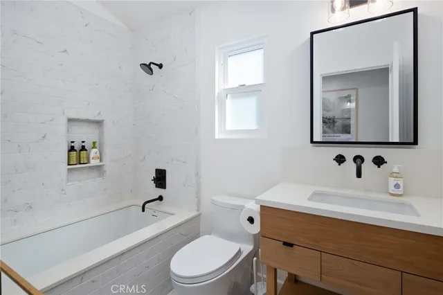 a bathroom with a sink a toilet and bathtub