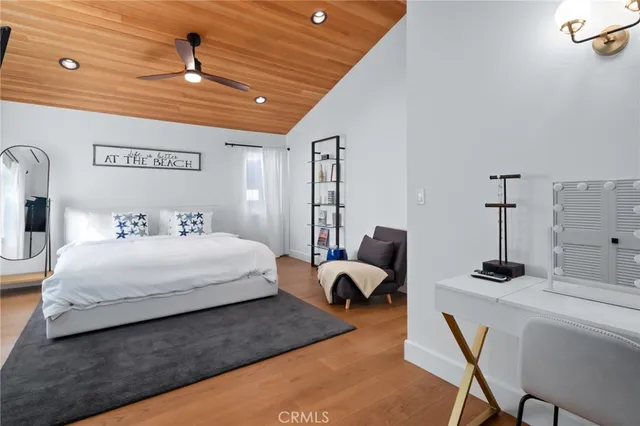 a spacious bedroom with a bed a window and couch