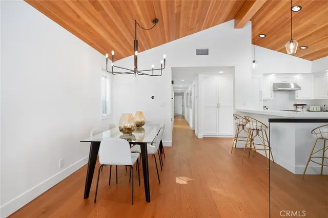 a dining room with furniture and wooden floor