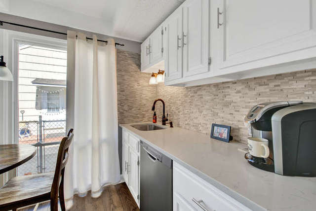 770 Spring Road Elmhurst, IL 60126 - Photo 13 of 35 a kitchen with stainless steel appliances a sink dishwasher a refrigerator and cabinets with wooden floor