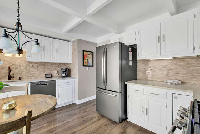 770 Spring Road Elmhurst, IL 60126 - Photo 18 of 35 a kitchen with white cabinets and stainless steel appliances