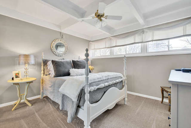 770 Spring Road Elmhurst, IL 60126 - Photo 25 of 35 a bedroom with a bed and a chandelier