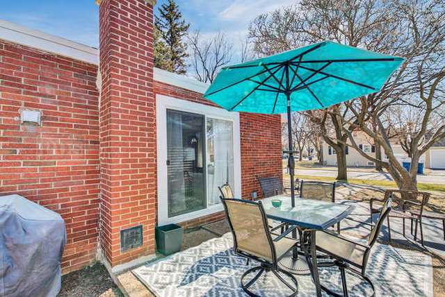 770 Spring Road Elmhurst, IL 60126 - Photo 35 of 35 a patio with a table and chairs under an umbrella
