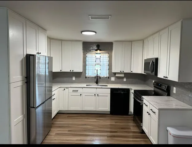 a kitchen with a sink stove and refrigerator