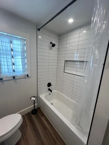 a bathroom with a bathtub and a toilet